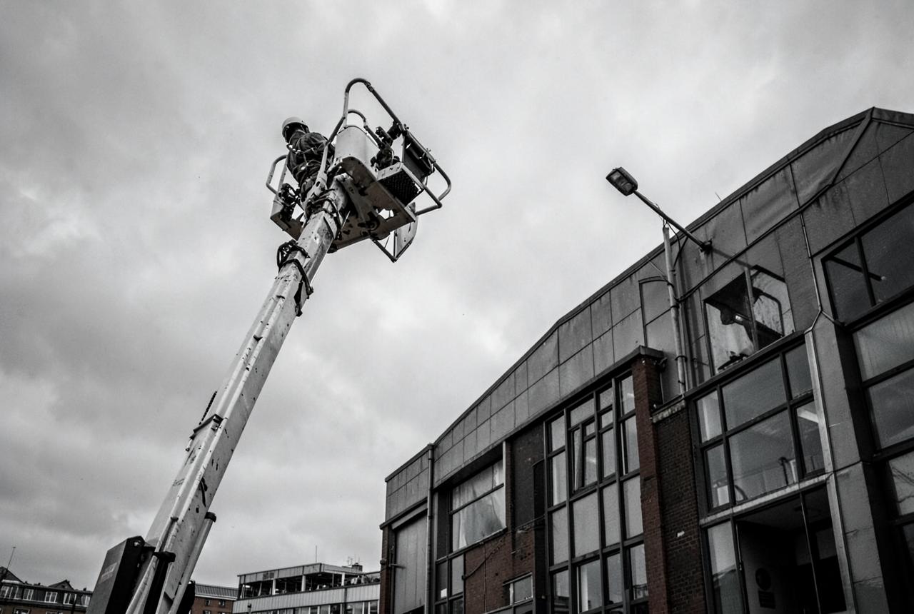 Boom lift raised beside a commercial building